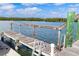 Dock with ladder offering easy access to the water, perfect for swimming and boating at 47 Jacaranda Cay Ct # 470, New Smyrna Beach, FL 32169