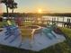 Community fire pit overlooking the water, with colorful Adirondack chairs surrounding at 47 Jacaranda Cay Ct # 470, New Smyrna Beach, FL 32169