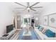 Inviting living room with beachy decor, open to kitchen and island at 47 Jacaranda Cay Ct # 470, New Smyrna Beach, FL 32169