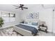 Serene main bedroom with a large window and a modern ceiling fan at 47 Jacaranda Cay Ct # 470, New Smyrna Beach, FL 32169