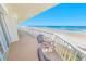 Balcony featuring ocean views and comfortable seating area at 4767 S Atlantic Ave # 404, Ponce Inlet, FL 32127