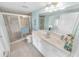 This bathroom has a spacious vanity with a shower and neutral tile flooring at 4767 S Atlantic Ave # 404, Ponce Inlet, FL 32127