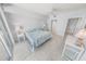 A bright bedroom featuring a comfortable king bed, tile floors, and an en-suite bathroom at 4767 S Atlantic Ave # 404, Ponce Inlet, FL 32127