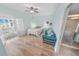 Bright bedroom with hardwood floors, a decorative daybed, and an ensuite bathroom at 4767 S Atlantic Ave # 404, Ponce Inlet, FL 32127