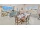 Open-concept dining and living area with views of the ocean from the balcony at 4767 S Atlantic Ave # 404, Ponce Inlet, FL 32127