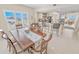 Bright dining room with a table and chairs, open to the kitchen with breakfast bar seating and view at 4767 S Atlantic Ave # 404, Ponce Inlet, FL 32127