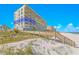 Condominium building on a sunny day near the sandy beach with a blue sky at 4767 S Atlantic Ave # 404, Ponce Inlet, FL 32127