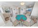 Open-concept living room with built-in shelves, a round dining table, and bright lighting at 4767 S Atlantic Ave # 404, Ponce Inlet, FL 32127