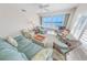 Bright living room with beach decor and ocean views at 4767 S Atlantic Ave # 404, Ponce Inlet, FL 32127