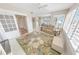 Inviting living room featuring a floral rug, comfy seating, and a view from the bright windows at 4767 S Atlantic Ave # 404, Ponce Inlet, FL 32127