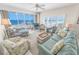 Bright living room boasting ocean views from the balcony, comfortable seating, and beachy decor at 4767 S Atlantic Ave # 404, Ponce Inlet, FL 32127