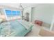 Bright bedroom featuring a king bed, tile floors and sliding glass doors to the balcony with ocean views at 4767 S Atlantic Ave # 404, Ponce Inlet, FL 32127