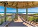 Scenic ocean view from inside a wooden pavilion overlooking a nearby boardwalk at 4767 S Atlantic Ave # 404, Ponce Inlet, FL 32127