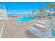 Community pool with lounge chairs, palm trees, and an ocean view at 4767 S Atlantic Ave # 404, Ponce Inlet, FL 32127