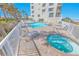 Relax by the sparkling pool and hot tub, surrounded by lush palm trees and comfortable lounge chairs at 4767 S Atlantic Ave # 404, Ponce Inlet, FL 32127