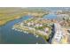 Aerial view of waterfront homes with private boat docks, serene waterways, and lush mangrove islands at 49 Jacaranda Cay Ct # 49, New Smyrna Beach, FL 32169