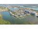 Panoramic aerial view of waterfront condo community with docks, showcasing its coastal location and tranquil waters at 49 Jacaranda Cay Ct # 49, New Smyrna Beach, FL 32169