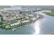 Wide aerial view of waterfront condos featuring private docks, mature landscaping, and a serene coastal setting at 49 Jacaranda Cay Ct # 49, New Smyrna Beach, FL 32169