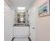 Bathroom vanity featuring modern fixtures, a tiled wall, and ample storage at 49 Jacaranda Cay Ct # 49, New Smyrna Beach, FL 32169