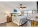 Comfortable bedroom featuring a queen bed, ceiling fan, and nautical decor at 49 Jacaranda Cay Ct # 49, New Smyrna Beach, FL 32169