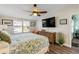 Bright bedroom featuring a ceiling fan, flat-screen TV, and woven dresser at 49 Jacaranda Cay Ct # 49, New Smyrna Beach, FL 32169