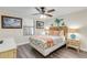 Cozy bedroom with ceiling fan, stylish furnishings and art at 49 Jacaranda Cay Ct # 49, New Smyrna Beach, FL 32169