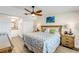 Bedroom with a queen bed, a ceiling fan, and nautical decor at 49 Jacaranda Cay Ct # 49, New Smyrna Beach, FL 32169