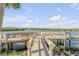 Scenic wooden dock on a sunny day offering a relaxing view of the tranquil waterway at 49 Jacaranda Cay Ct # 49, New Smyrna Beach, FL 32169