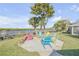 A beautiful firepit area with colorful chairs overlooking the waterway at 49 Jacaranda Cay Ct # 49, New Smyrna Beach, FL 32169