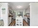 Modern kitchen featuring stainless steel appliances, granite countertops, and an island with shelving at 49 Jacaranda Cay Ct # 49, New Smyrna Beach, FL 32169