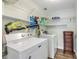 Modern laundry room with washer, dryer, storage, and a leaf blower at 49 Jacaranda Cay Ct # 49, New Smyrna Beach, FL 32169