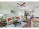 Comfortable living room with a ceiling fan, light green walls, and an open floor plan at 49 Jacaranda Cay Ct # 49, New Smyrna Beach, FL 32169