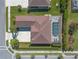 Aerial view of a home featuring a private screened-in pool, well-maintained landscaping, and a spacious driveway at 512 Romdini St, New Smyrna Beach, FL 32168