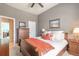 Bedroom with wood furnishings, neutral colors, and a large picture window at 512 Romdini St, New Smyrna Beach, FL 32168