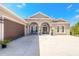 Elegant home with a well-manicured lawn, a three-car garage, and a welcoming front entrance at 512 Romdini St, New Smyrna Beach, FL 32168