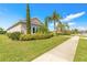 Manicured front yard with lush landscaping and inviting curb appeal at 512 Romdini St, New Smyrna Beach, FL 32168