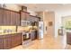 Modern kitchen with stainless steel appliances, dark wood cabinetry, and granite countertops at 512 Romdini St, New Smyrna Beach, FL 32168