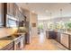 Modern kitchen with stainless steel appliances, granite countertops, and dark wood cabinets at 512 Romdini St, New Smyrna Beach, FL 32168