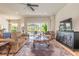 This comfortable living room has a large patterned rug and a view of the pool at 512 Romdini St, New Smyrna Beach, FL 32168