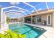 Inviting screened-in pool with a seating area and clear blue skies reflecting in the water at 512 Romdini St, New Smyrna Beach, FL 32168