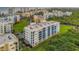 Exterior shot of a multi-story building with a light blue and yellow exterior and surrounded by landscaped grounds at 5300 S Atlantic Ave # 5-407, New Smyrna Beach, FL 32169