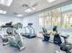 Fitness center featuring cardio machines, ceiling fan, and a large window with a blue railing outside at 5300 S Atlantic Ave # 5-407, New Smyrna Beach, FL 32169