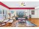 Well-lit living room with hardwood floors and a large window with plantation shutters at 5300 S Atlantic Ave # 5-407, New Smyrna Beach, FL 32169