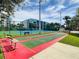 Shuffleboard courts, tennis courts and seating with the condo buildings in the background at 5300 S Atlantic Ave # 5-407, New Smyrna Beach, FL 32169