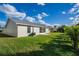 Home exterior featuring a well-maintained lawn and partial view of the house at 5431 Landis Ave, Port Orange, FL 32127