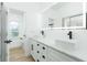 Bright bathroom featuring dual sinks, a large mirror and modern finishes at 5431 Landis Ave, Port Orange, FL 32127