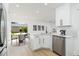 Modern kitchen featuring white cabinets, stainless steel appliances, and an adjoining dining area at 5431 Landis Ave, Port Orange, FL 32127