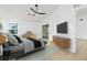 Bright main bedroom featuring a ceiling fan, modern furniture and sliding glass doors to the outside at 5431 Landis Ave, Port Orange, FL 32127