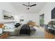 Well-lit main bedroom with a large bed, ceiling fan, modern furniture and sliding glass door at 5431 Landis Ave, Port Orange, FL 32127