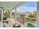 Relaxing balcony with wicker furniture overlooks tropical backyard with pool at 604 S Atlantic Ave, New Smyrna Beach, FL 32169